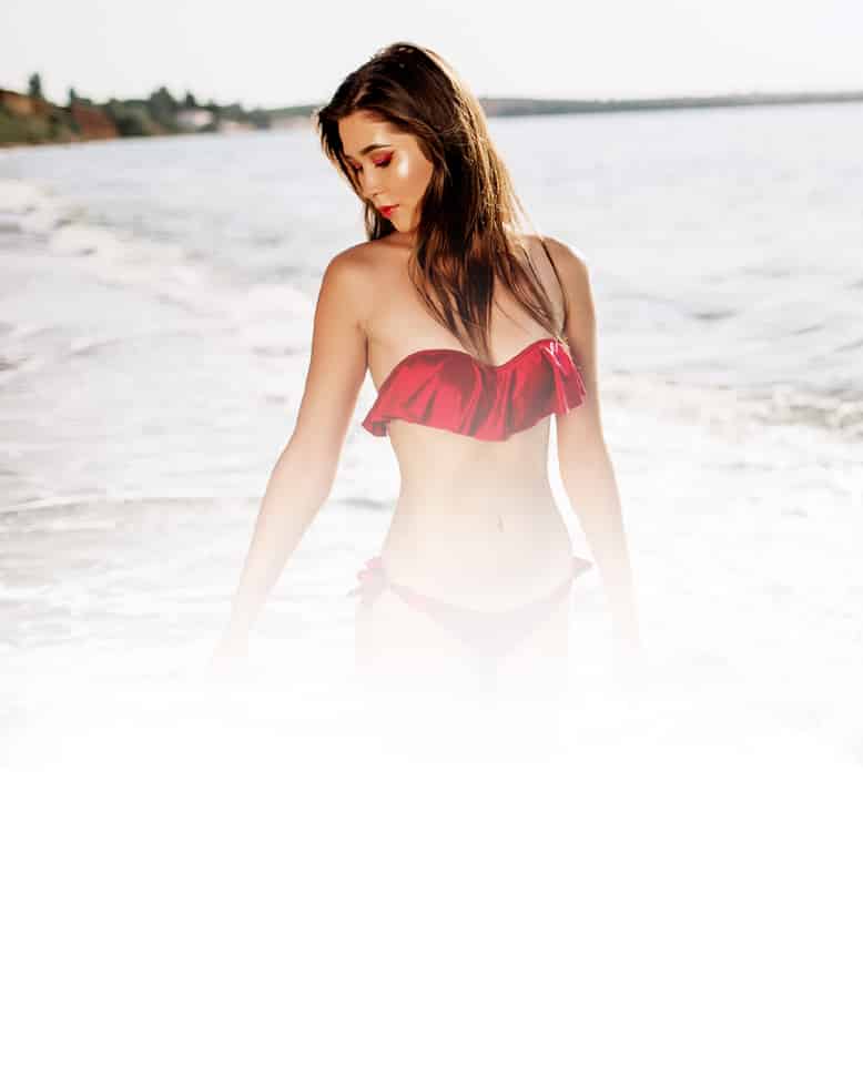 a woman standing next to the ocean